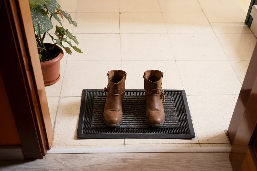 boots-at-the-entrance-of-the-house-on-the-doormat-2022-04-22-07-23-38-utc.Z819KwU.webp